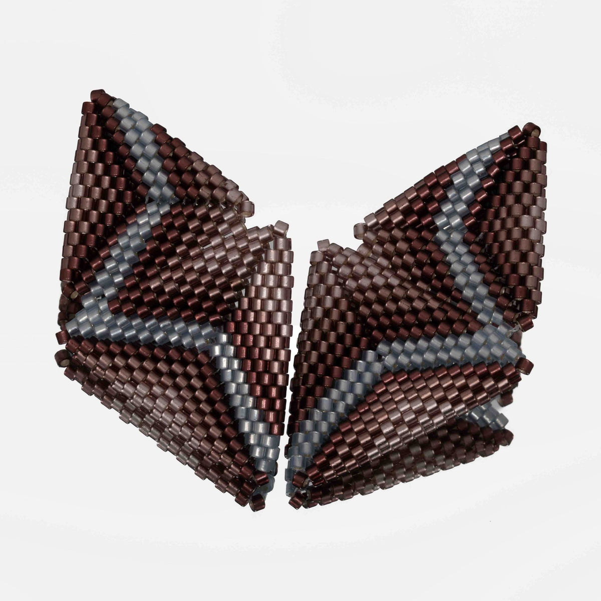 Pair of plum ombre and light sapphire beaded statement earrings, each made of two joined triangles, with diagonal bands on a mirror