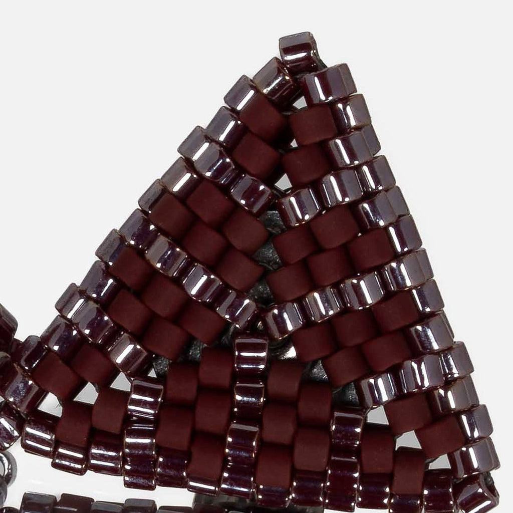Close-up of matte and glossy burgundy cylinder beads woven in peyote stitch