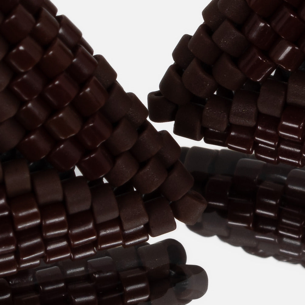 Close-up of glossy chocolate and matte espresso cylinder beads woven in peyote stitch