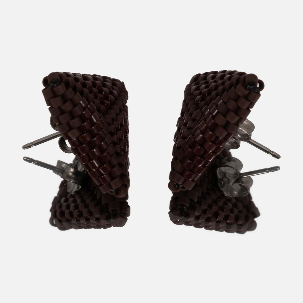 Pair of chocolate brown beaded triangle earrings facing each other on a mirror, showing the titanium posts and the woven edges