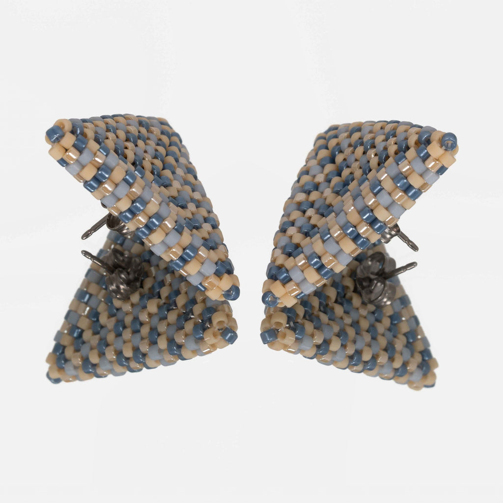 Back of the dusty blue, denim, and tan beaded triangle earrings, showing titanium posts and butterfly backs