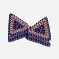 Pair of hand-woven beaded triangle earrings in frosted lilac, cobalt blue, and matte bone, standing on a mirror