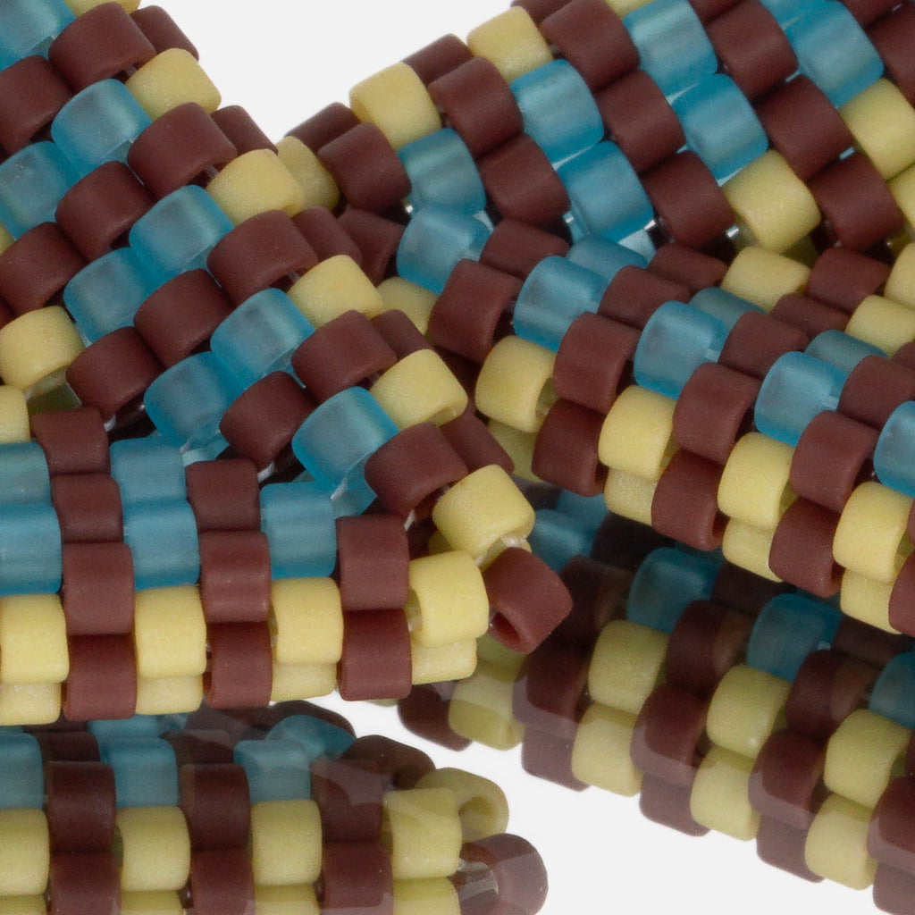 Close-up of frosted oxblood, aqua, and matte spring green cylinder beads woven in peyote stitch