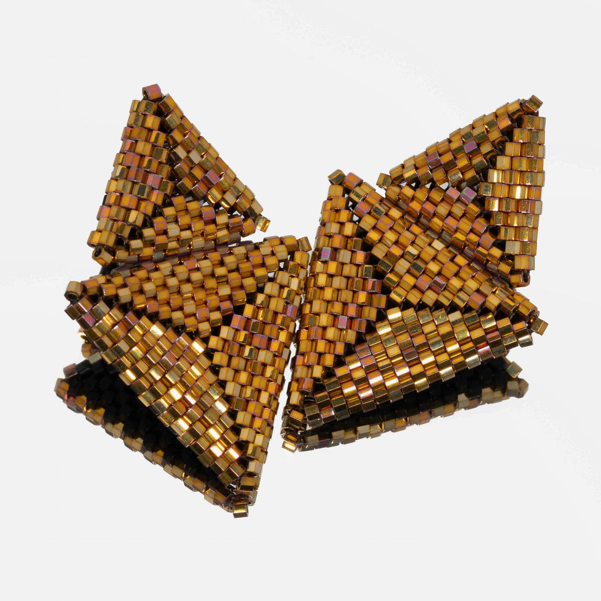 Pair of hand-woven metallic gold beaded triangle earrings, standing on a mirror