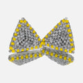 Pair of small hand-woven beaded triangle earrings in mottled gray with yellow edges, standing on a mirror
