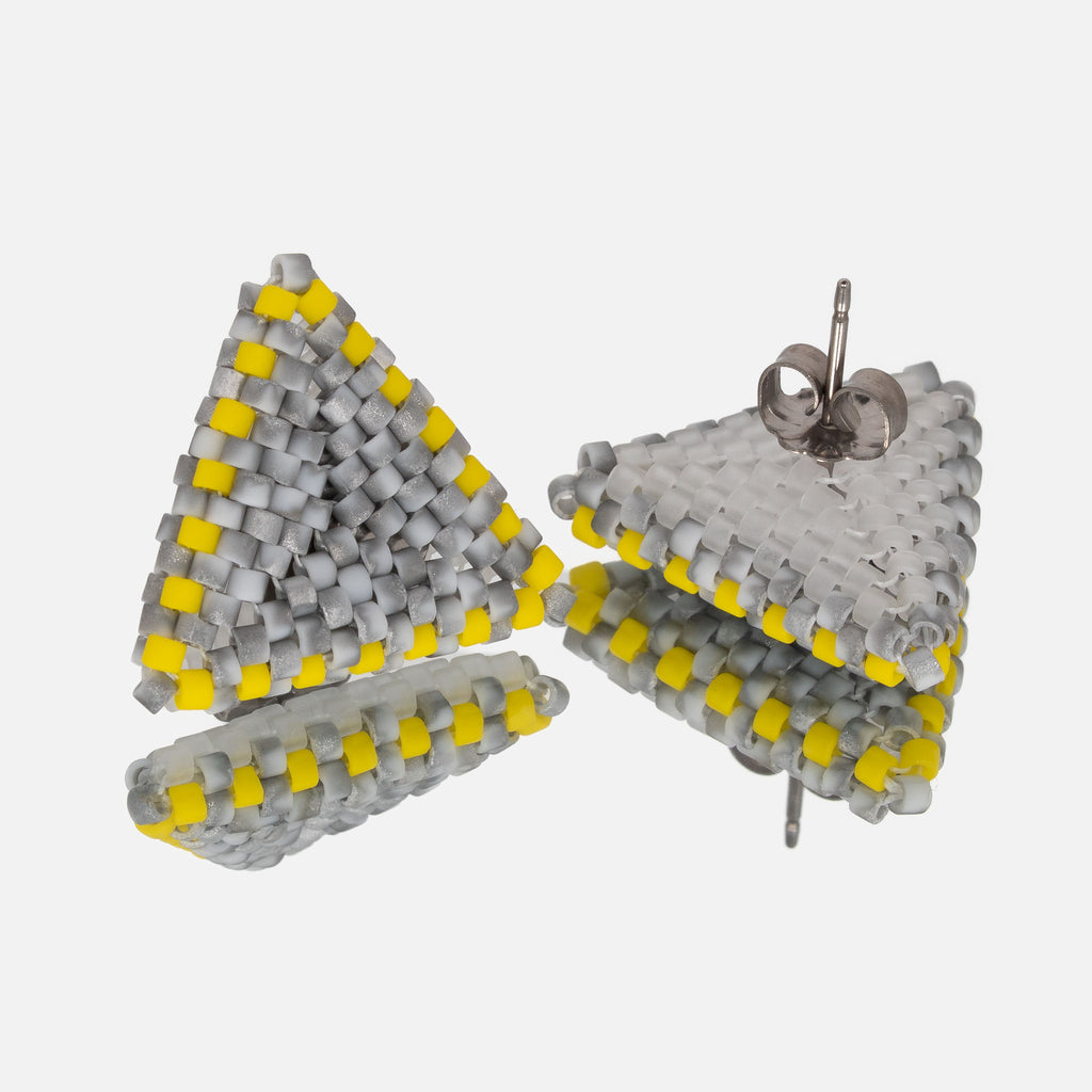 Back of the gray and yellow beaded triangle earrings, showing the crystal white back, titanium posts, and butterfly backs