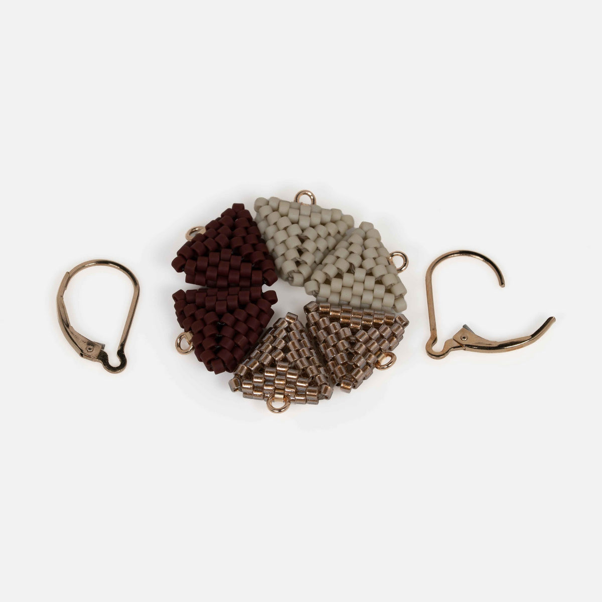 Three pairs of interchangeable beaded triangle modules in greige, antique copper, and oxblood, with one pair of gold-filled lever-backs.