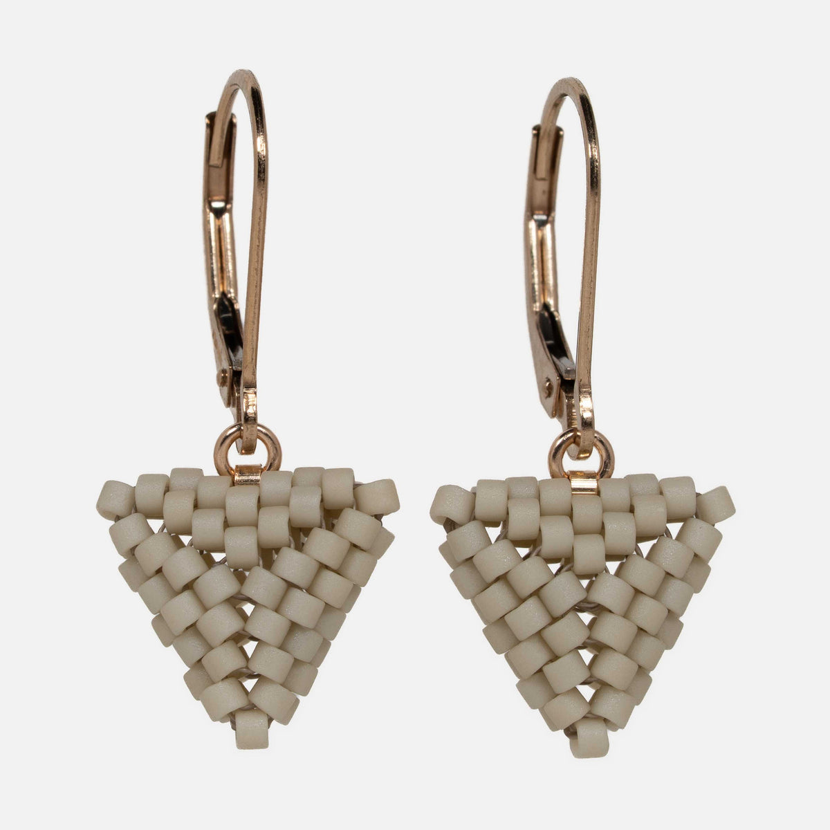 Pair of hand-woven greige beaded triangle earrings on gold-filled lever-backs, hanging against a white background.