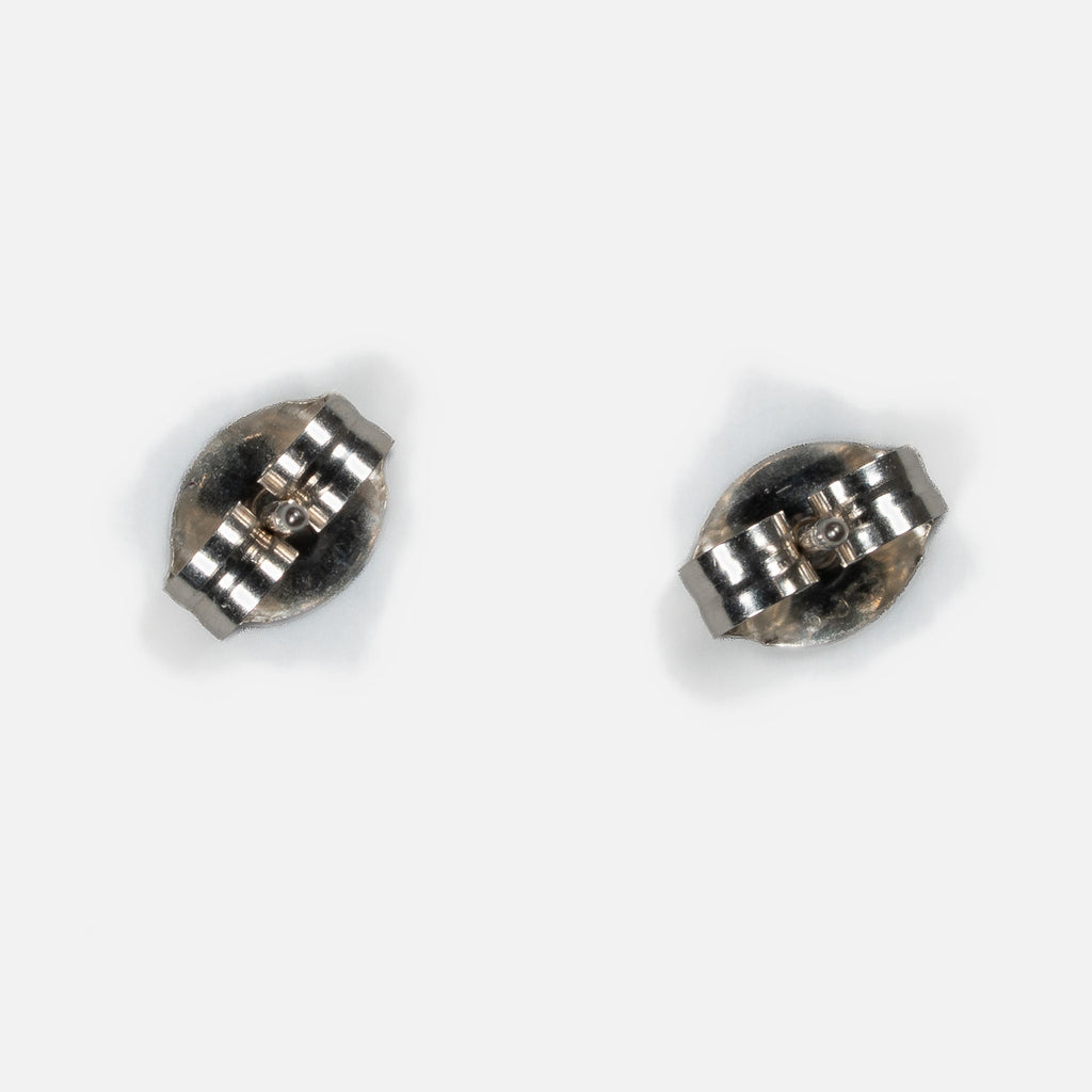 Back of a pair of MINIMA beaded stud earrings, showing sterling silver posts and friction ear nuts