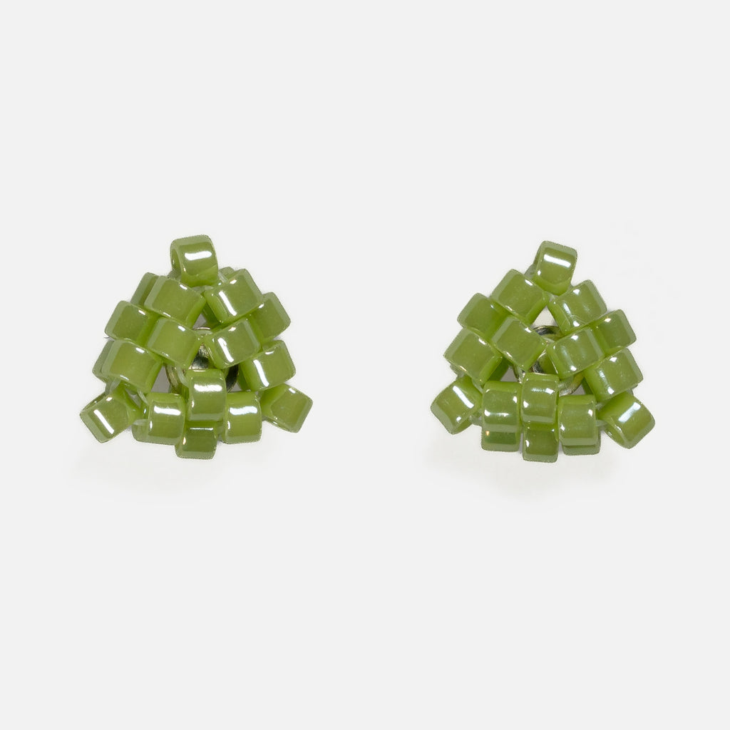 Pair of tiny triangular beaded stud earrings in soft matcha green with a pearly luster, front view on a light gray background