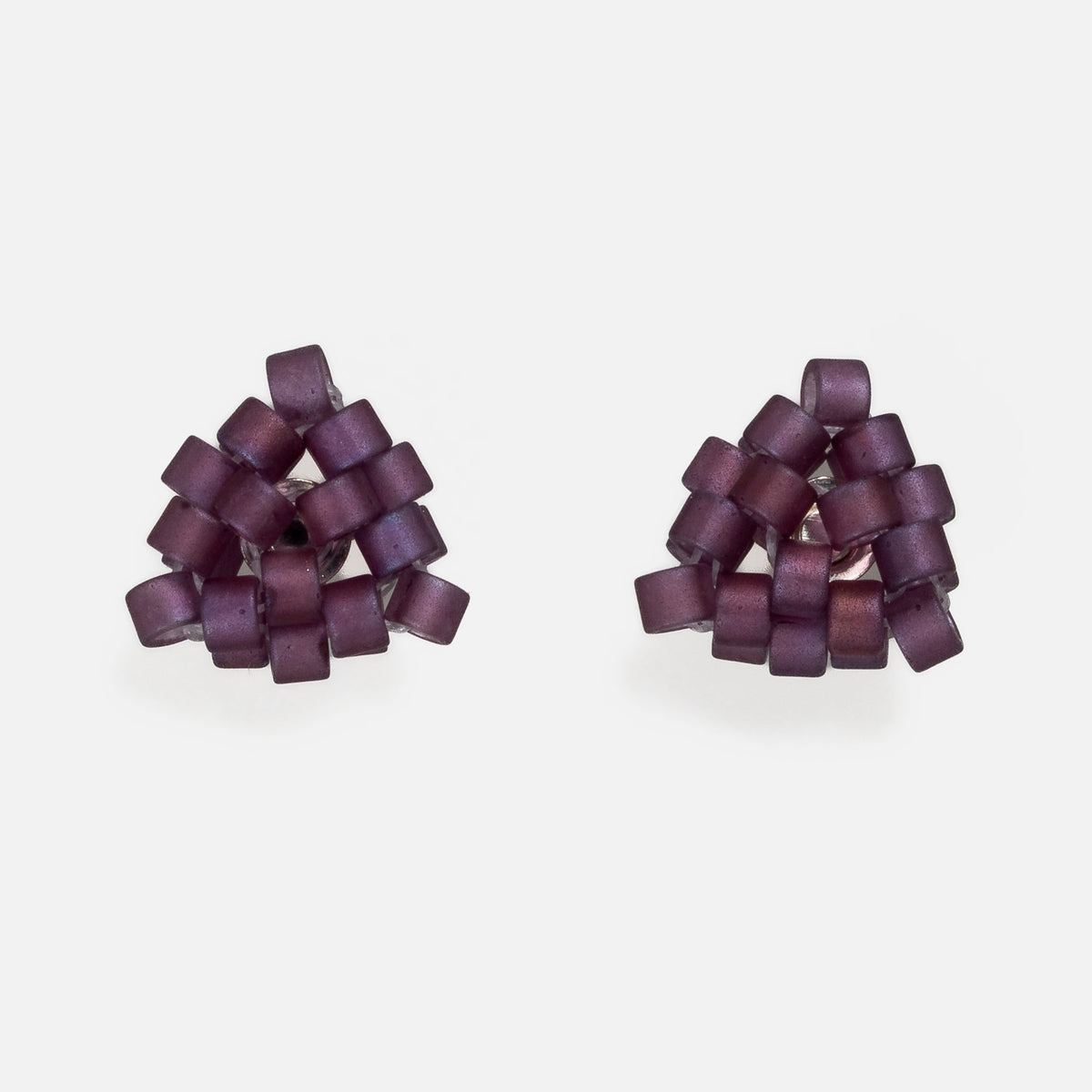 Pair of tiny triangular beaded stud earrings in frosted matte mulberry purple with a soft shimmer, front view on a light gray background