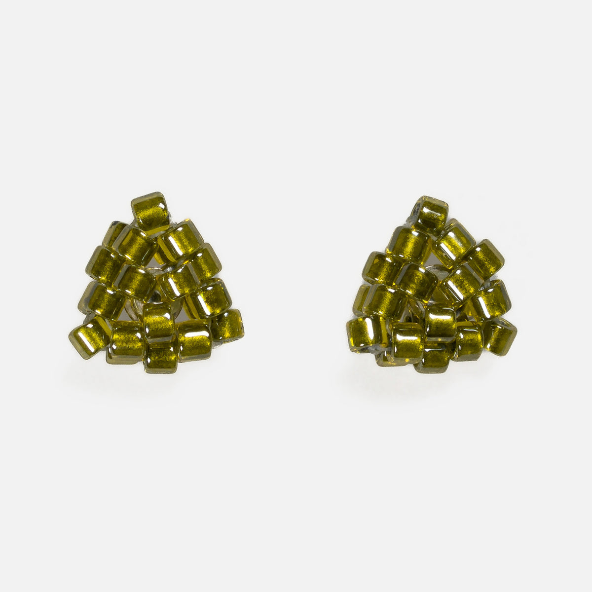 Pair of tiny triangular beaded stud earrings in golden olive green silver-lined beads, front view on a light gray background
