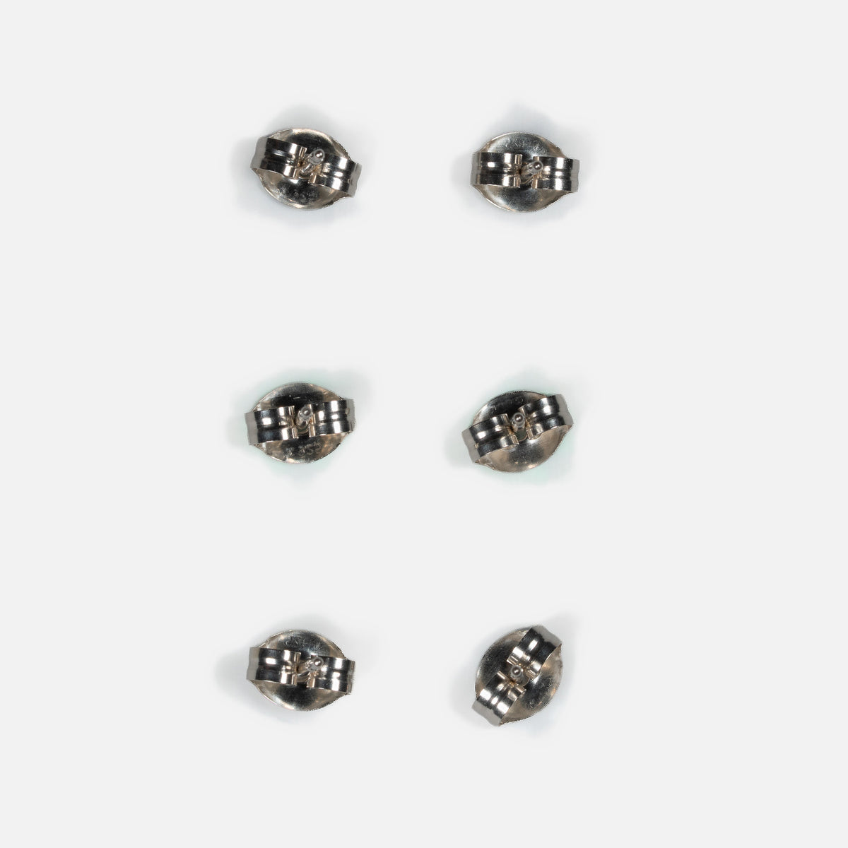 Back of three pairs of MINIMA beaded stud earrings, showing sterling silver posts and friction ear nuts