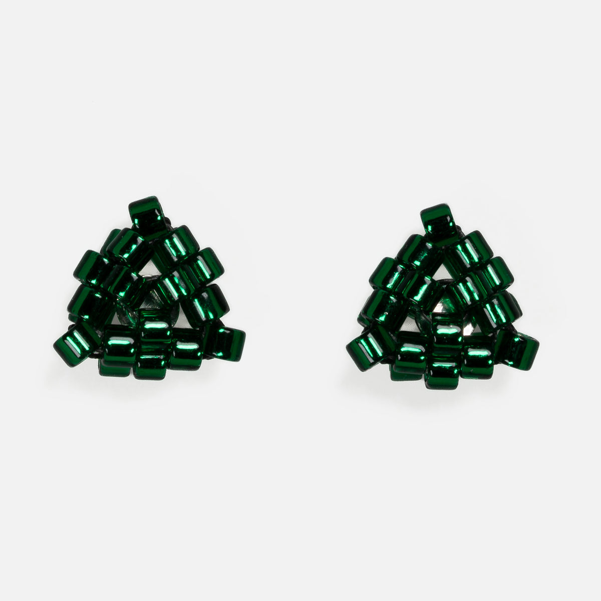 Pair of tiny triangular beaded stud earrings in silver-lined emerald green, front view on a light gray background