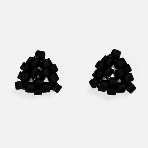 Pair of tiny triangular beaded stud earrings in flat matte black, front view on a light gray background