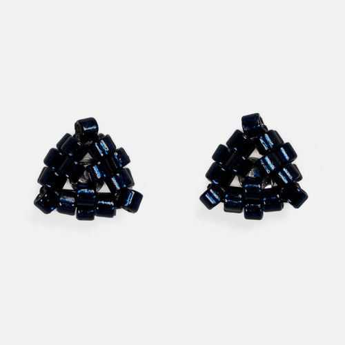 Pair of tiny triangular beaded stud earrings in silver-lined midnight blue, front view on a light gray background