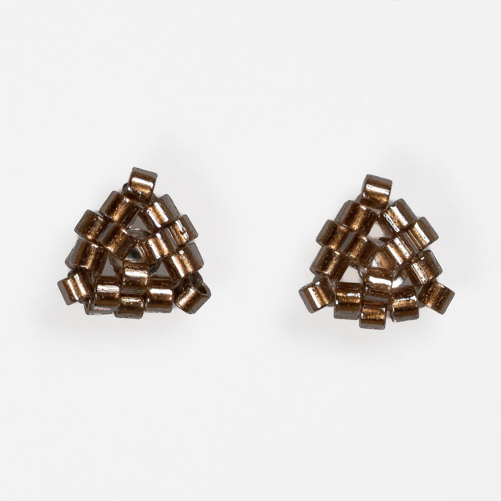 Pair of tiny triangular beaded stud earrings in antique copper-lined glass beads, front view on a light gray background