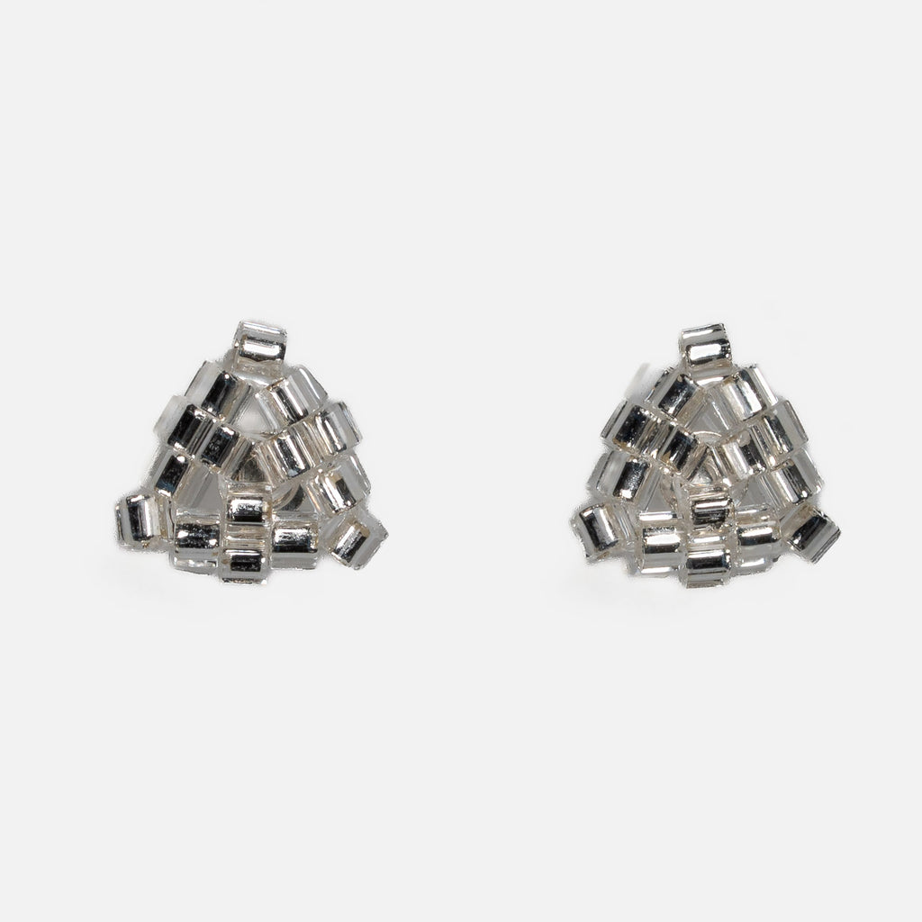 Pair of tiny triangular beaded stud earrings in silver-lined crystal hex beads, front view on a light gray background