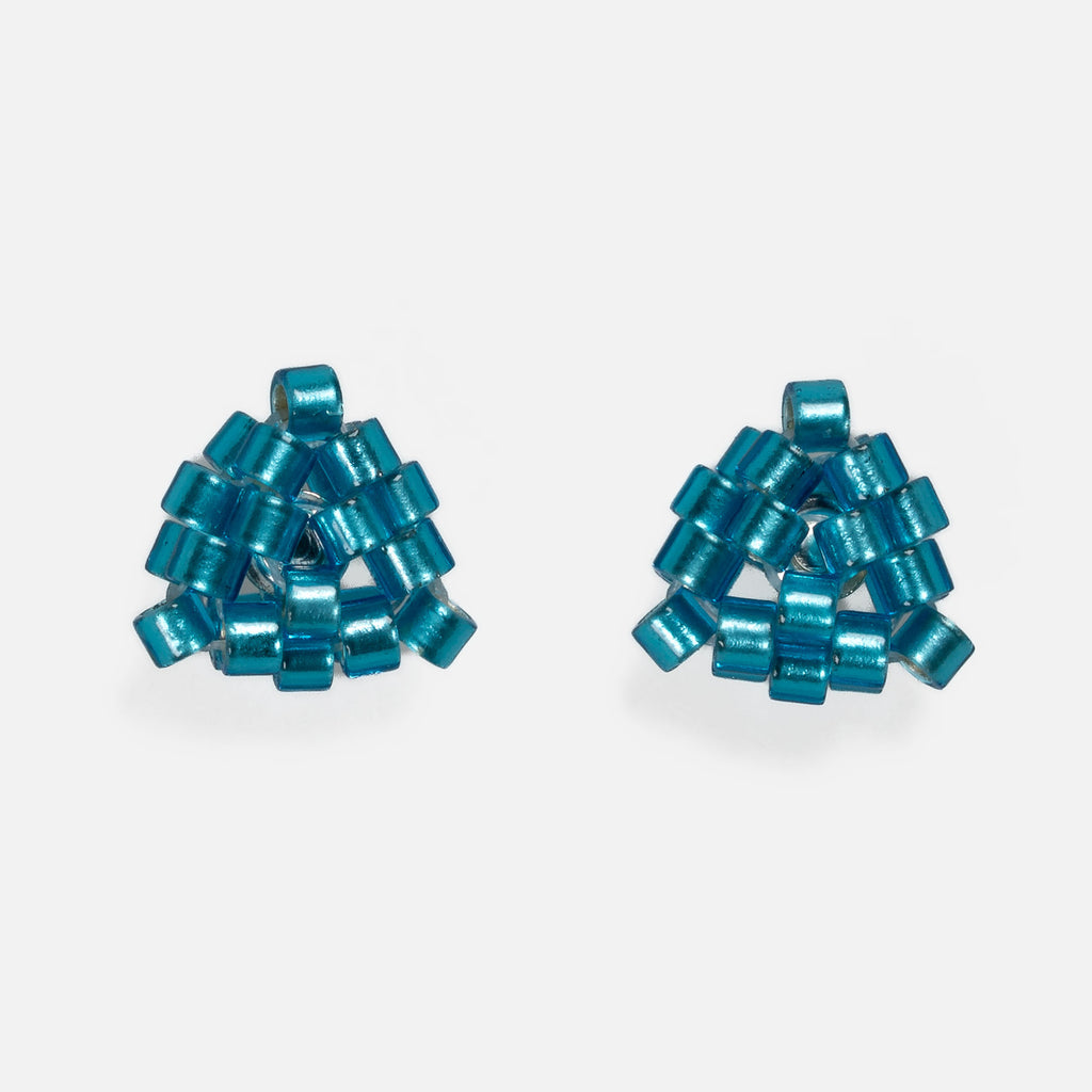 Pair of tiny triangular beaded stud earrings in bright silver-lined teal, front view on a light gray background