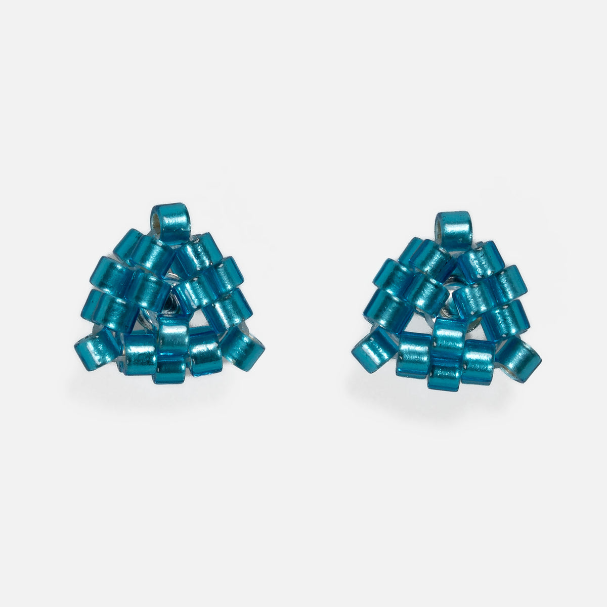 Pair of tiny triangular beaded stud earrings in bright silver-lined teal, front view on a light gray background
