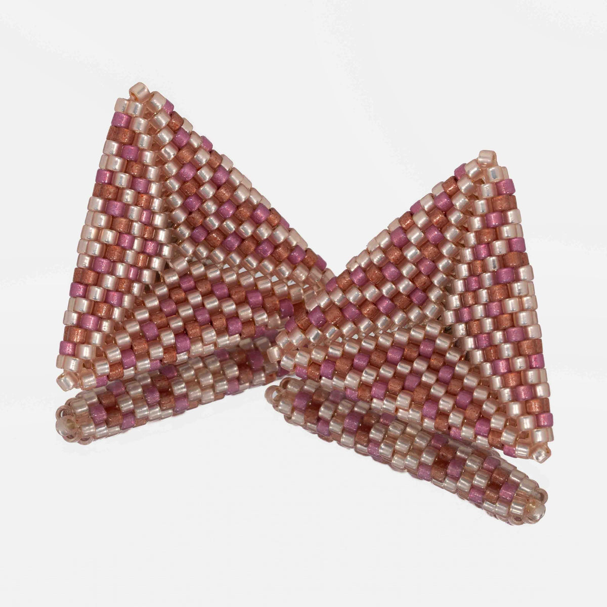 Pair of hand-woven peach, berry, and brick beaded triangle earrings, standing on a mirror
