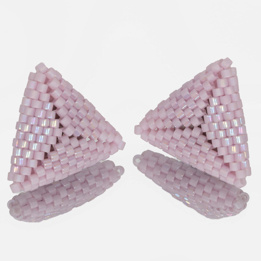 Pair of hand-woven pink lilac beaded triangle earrings, standing on a mirror