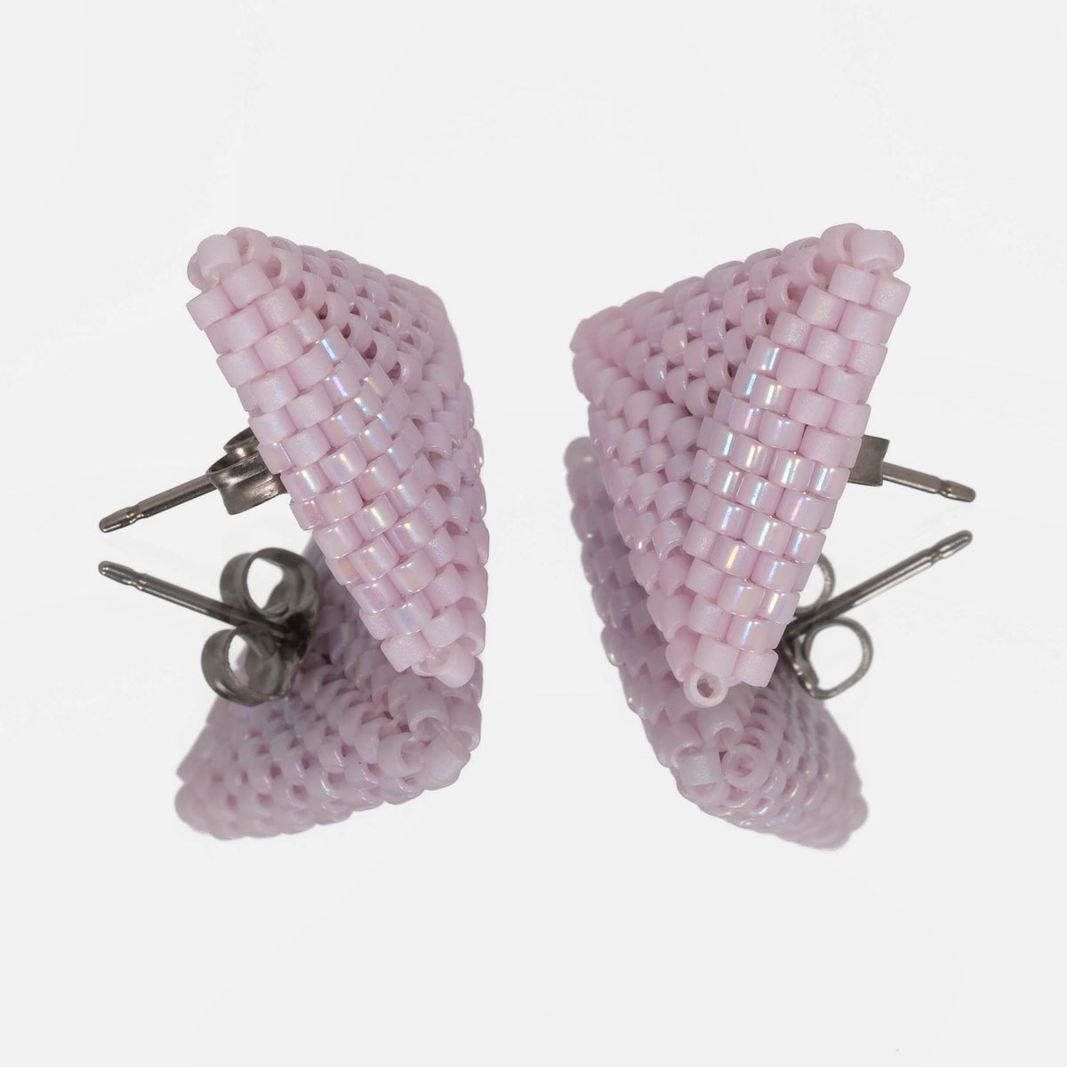 Back of the pink lilac beaded triangle earrings, showing titanium posts and butterfly backs