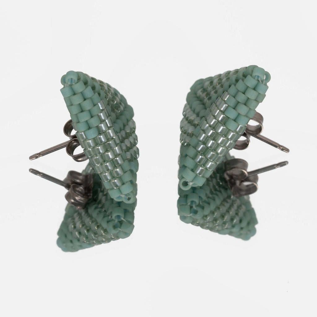 Back of the sea green beaded triangle earrings, showing titanium posts and butterfly backs