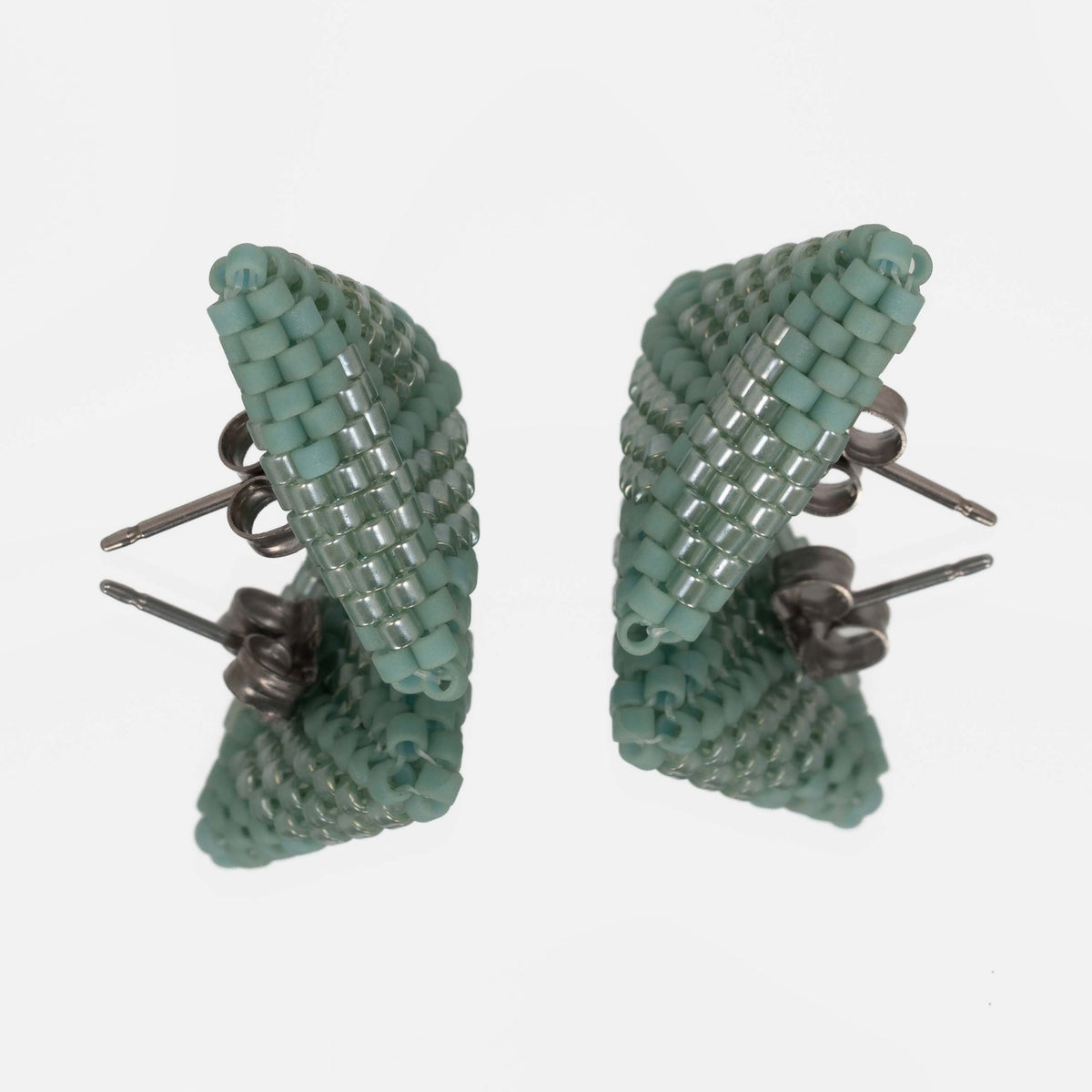 Back of the sea green beaded triangle earrings, showing titanium posts and butterfly backs