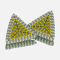 Pair of hand-woven beaded triangle earrings with matte seafoam, beige, and lemon stripes, standing on a mirror
