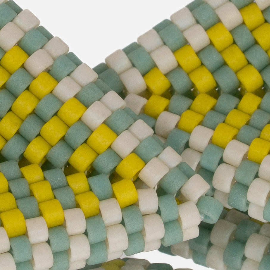 Close-up of matte seafoam, beige, and lemon cylinder beads woven in peyote stitch
